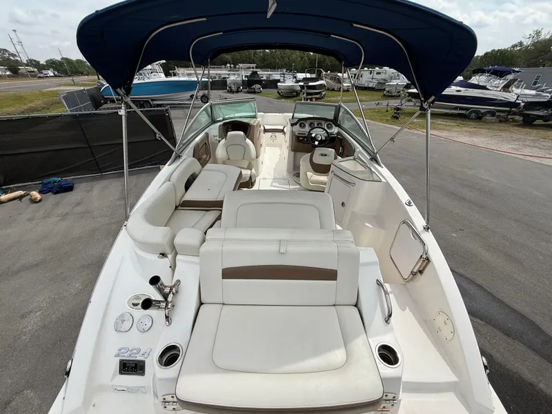 Slide: The Image of 2015 Chaparral Sunesta 224 boat with spacious seating and blue canopy. - 16
