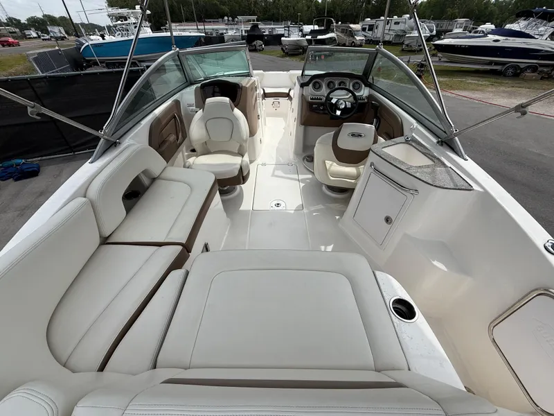 Slide: The Image of 2015 Chaparral Sunesta 224 boat interior with spacious seating and modern dashboard. - 19