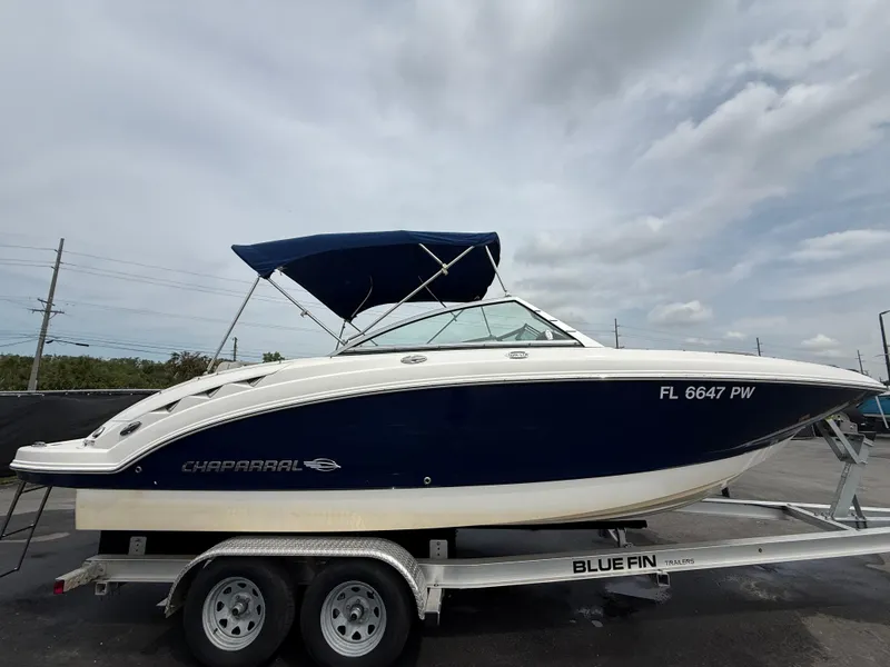 Slide: The Image of 2015 Chaparral Sunesta 224 boat on trailer with blue canopy. - 2