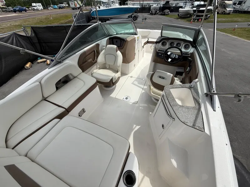 Slide: The Image of 2015 Chaparral Sunesta 224 boat interior with seating and steering console. - 20