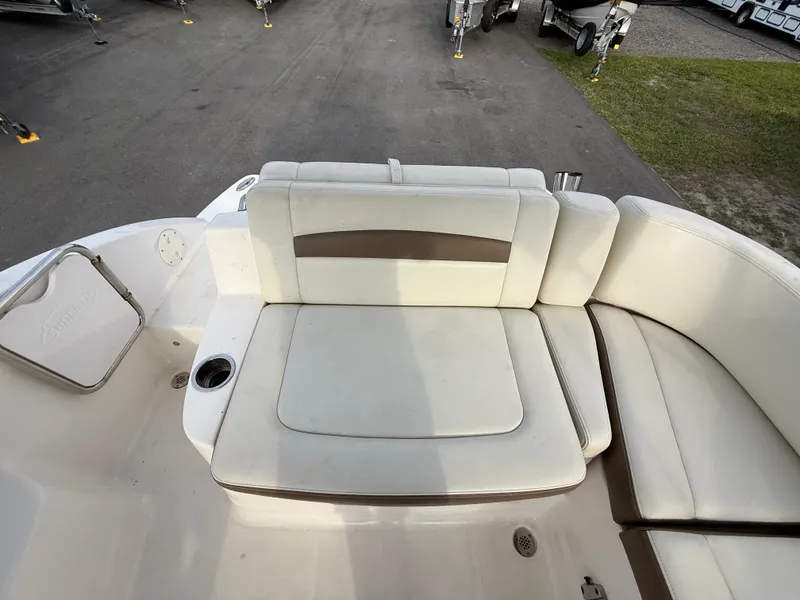 Slide: The Image of 2015 Chaparral Sunesta 224 boat interior with white and beige seating. - 21