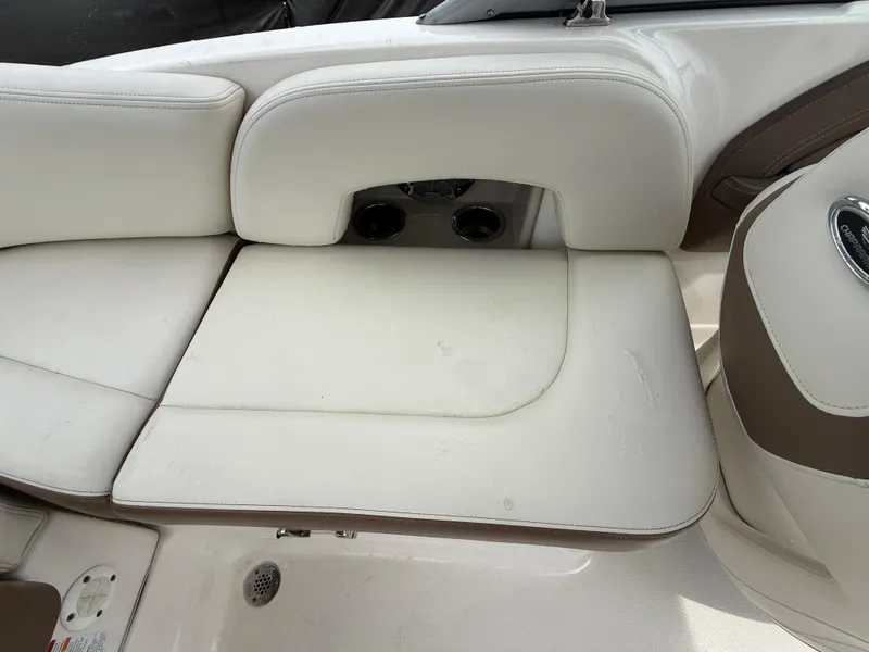 Slide: The Image of 2015 Chaparral Sunesta 224 boat interior with white cushioned seating. - 26