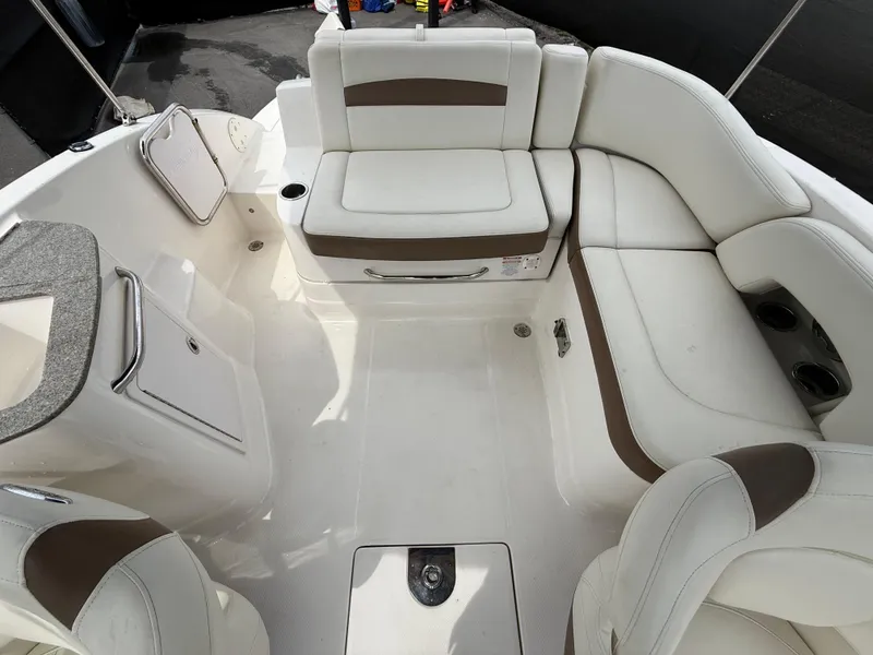 Slide: The Image of 2015 Chaparral Sunesta 224 boat interior with white and brown seating. - 28