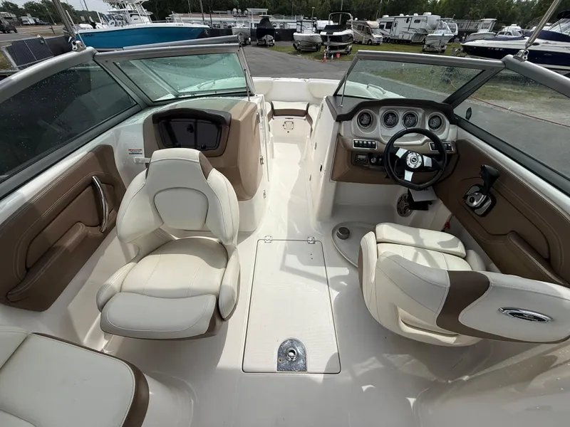 Slide: The Image of 2015 Chaparral Sunesta 224 boat interior with beige seating and dashboard. - 32