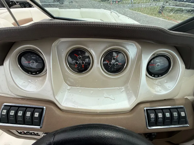 Slide: The Image of Dashboard of 2015 Chaparral Sunesta 224 boat with gauges and control switches. - 38