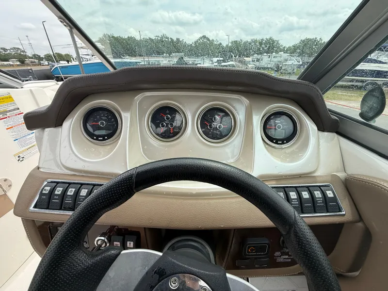 Slide: The Image of Dashboard of 2015 Chaparral Sunesta 224 boat with gauges and steering wheel. - 39
