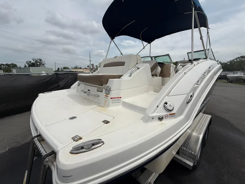Slide: The Image of 2015 Chaparral Sunesta 224 boat with blue canopy on trailer, rear view. - 4
