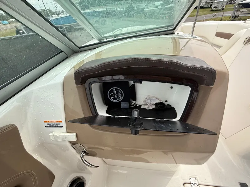 Slide: The Image of 2015 Chaparral Sunesta 224 boat dashboard with open glove compartment. - 43