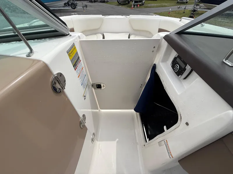 Slide: The Image of 2015 Chaparral Sunesta 224 boat interior, featuring storage compartment and seating area. - 47