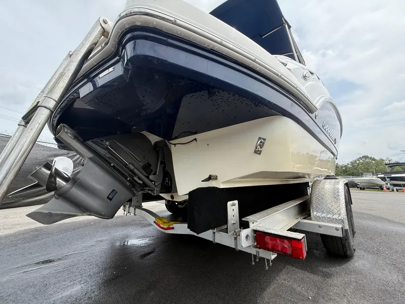 Slide: The Image of 2015 Chaparral Sunesta 224 boat on trailer, rear view showing hull and outboard motor. - 5