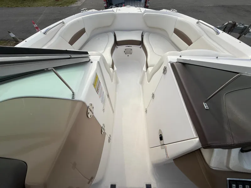 Slide: The Image of 2015 Chaparral Sunesta 224 boat interior with white and brown seating. - 50