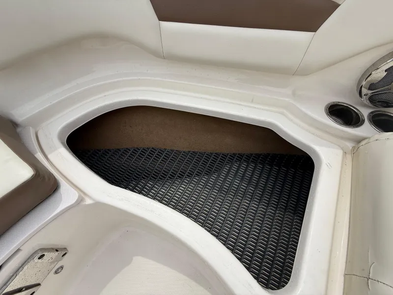Slide: The Image of 2015 Chaparral Sunesta 224 boat interior storage compartment with cup holders. - 53