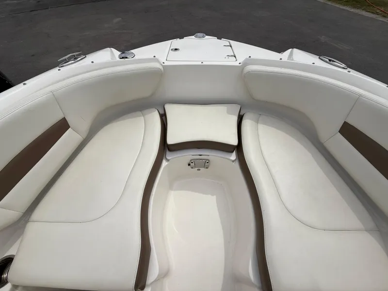 Slide: The Image of 2015 Chaparral Sunesta 224 boat interior with white cushioned seating. - 55