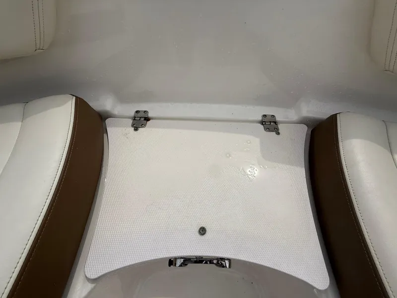 Slide: The Image of 2015 Chaparral Sunesta 224 boat seating area with white and brown upholstery. - 56