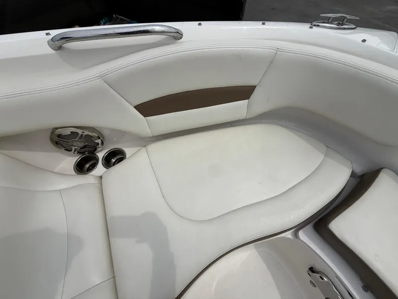 Slide: The Image of 2015 Chaparral Sunesta 224 boat interior with white seating and cup holders. - 58