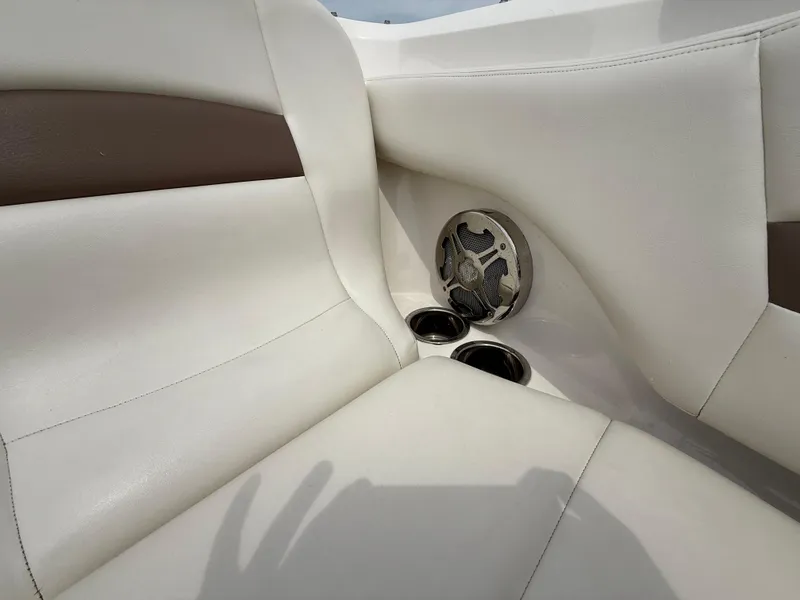 Slide: The Image of 2015 Chaparral Sunesta 224 boat interior with white seating and speaker. - 60