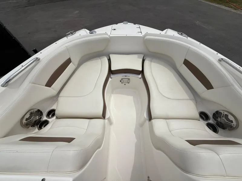 Slide: The Image of 2015 Chaparral Sunesta 224 boat interior with white seating and cup holders. - 61