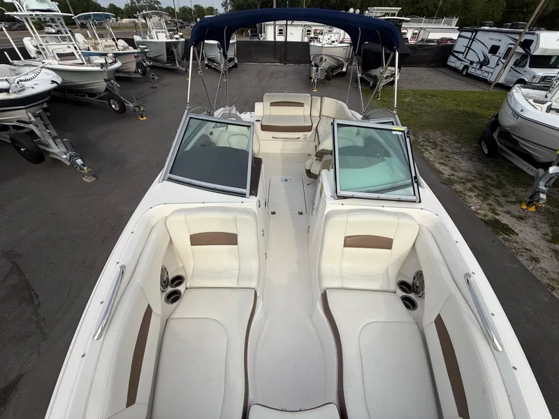 Slide: The Image of 2015 Chaparral Sunesta 224 boat with spacious seating and open deck layout. - 62