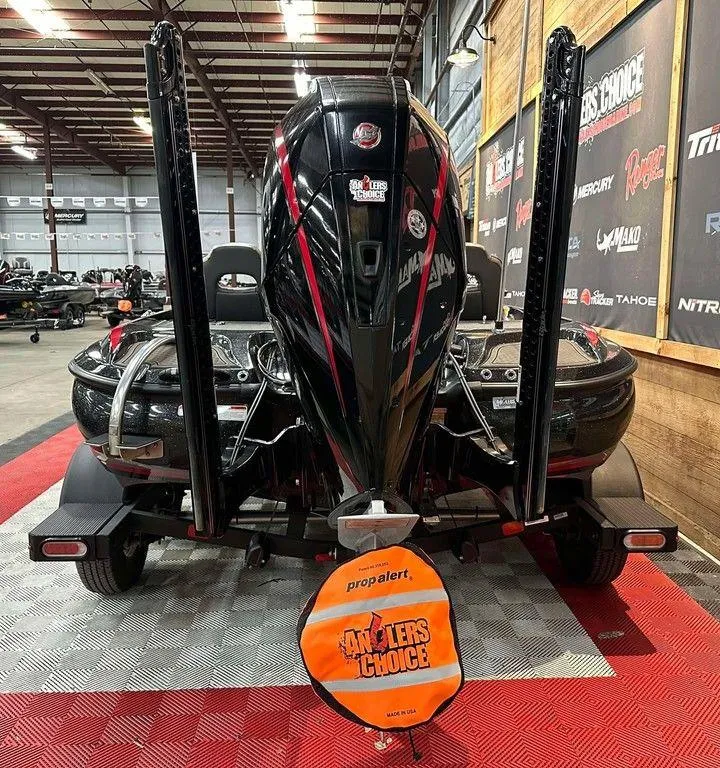 Slide: The Image of 2023 Nitro Z19 Pro boat in showroom, rear view with propeller cover. - 2