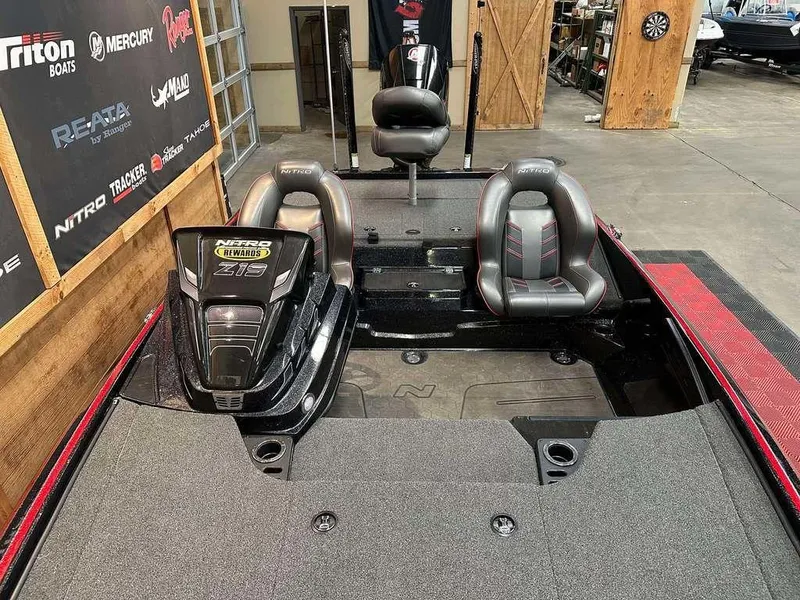 Slide: The Image of 2023 Nitro Z19 Pro boat interior with dual seats and motor in a showroom. - 9