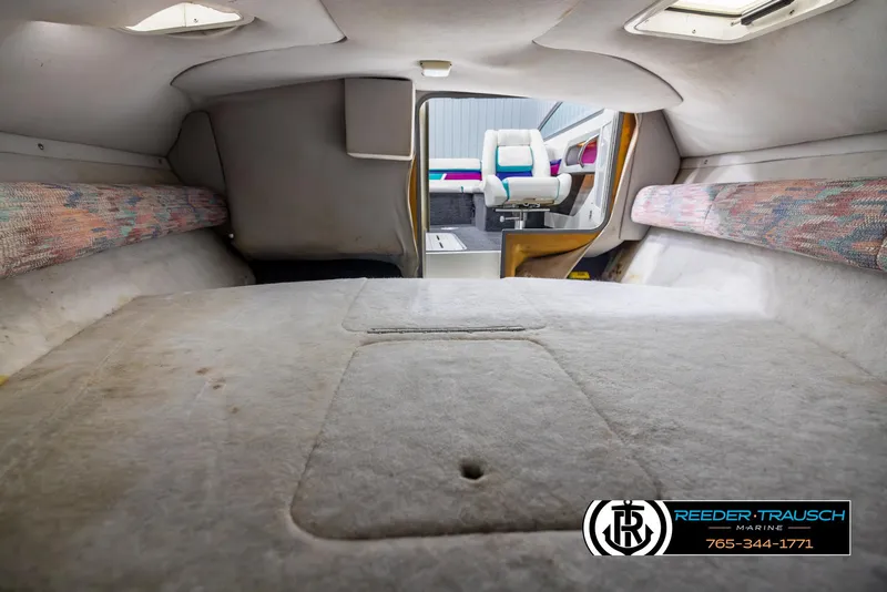 Slide: The Image of Interior of a 1996 Thunderbird Falcon 2270 CD boat cabin with seating and storage. - 15