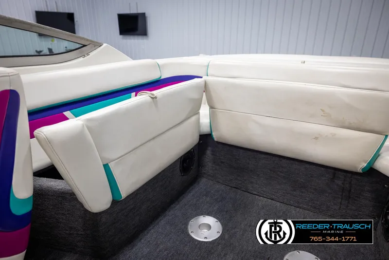 Slide: The Image of Interior of a 1996 Thunderbird Falcon 2270 CD boat with white and colorful upholstery. - 19
