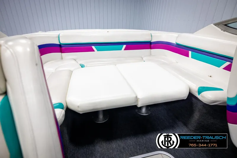 Slide: The Image of 1996 Thunderbird Falcon 2270 CD boat interior with white, teal, and purple seating. - 21