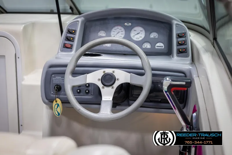 Slide: The Image of 1996 Thunderbird Falcon 2270 CD boat dashboard with steering wheel and control panel. - 22
