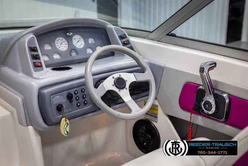 Slide: The Image of 1996 Thunderbird Falcon 2270 CD boat dashboard with steering wheel and control panel. - 23