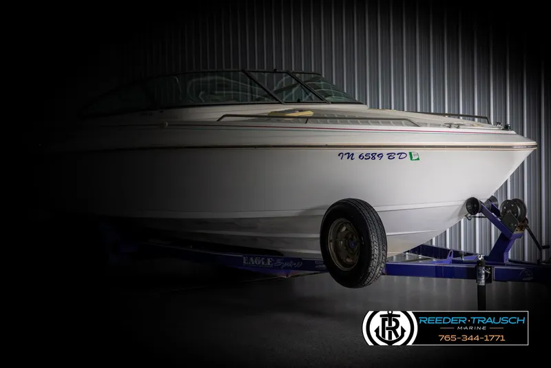 Slide: The Image of 1996 Thunderbird Falcon 2270 CD boat on trailer in dimly lit storage. - 3