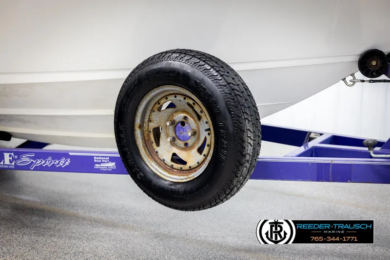 Slide: The Image of 1996 Thunderbird Falcon 2270 CD boat trailer wheel on blue frame. - 47