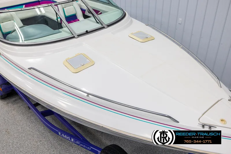 Slide: The Image of 1996 Thunderbird Falcon 2270 CD boat on trailer, white exterior with colorful accents. - 8