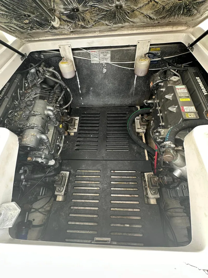 Slide: The Image of Engine compartment of a 2006 Luhrs 28 Open boat, showcasing dual engines. - 14