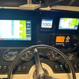 Slide: The Image of Control panel of a 2006 Luhrs 28 Open boat with navigation screens and gauges. - 6