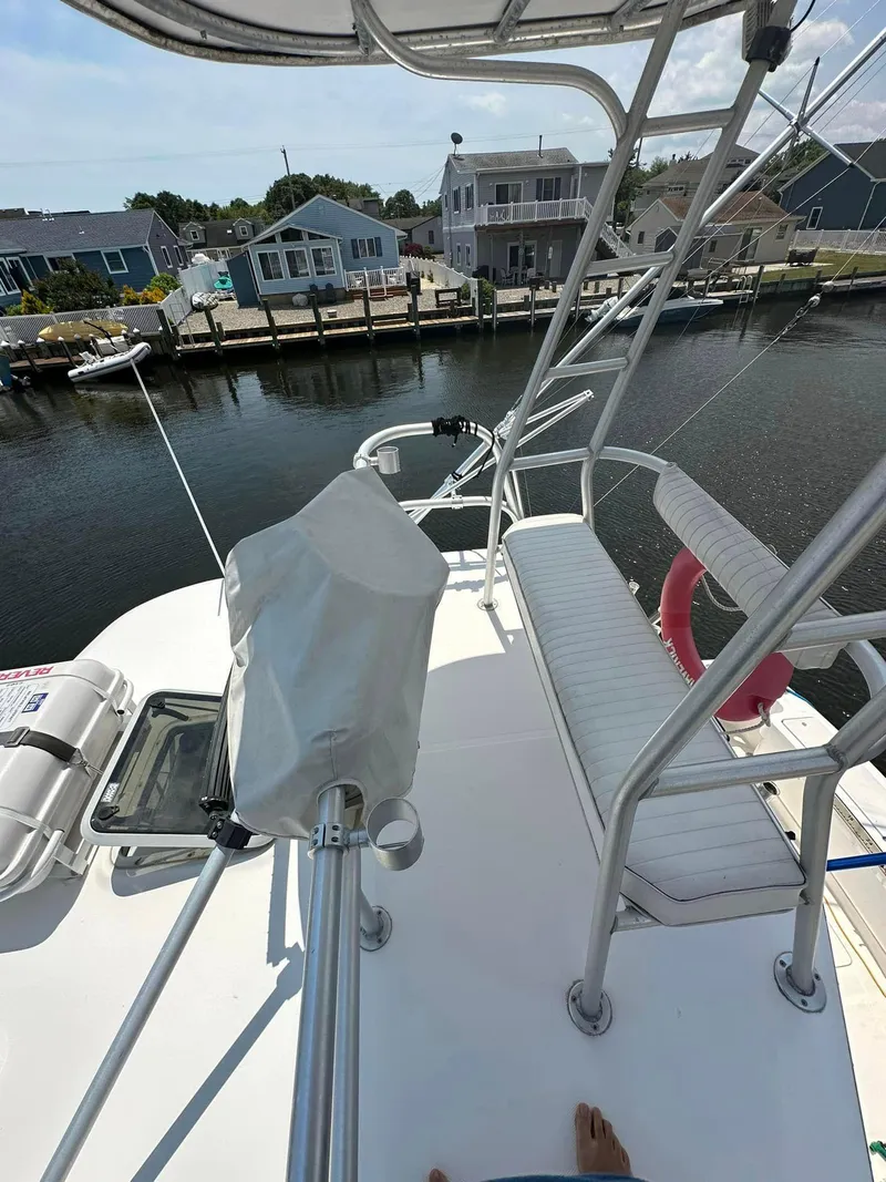 Slide: The Image of 2006 Luhrs 28 Open boat with elevated seating, docked near waterfront homes. - 7
