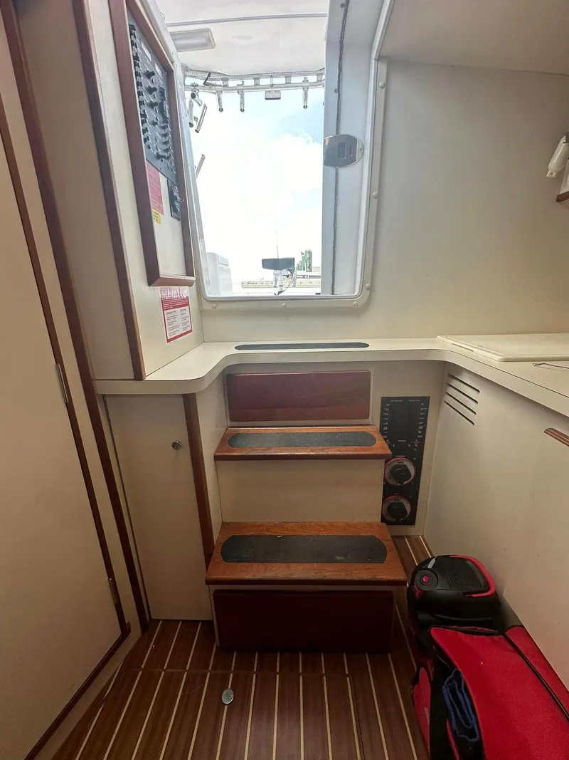 Slide: The Image of 2006 Luhrs 28 Open cabin interior with wooden steps and nautical equipment. - 8
