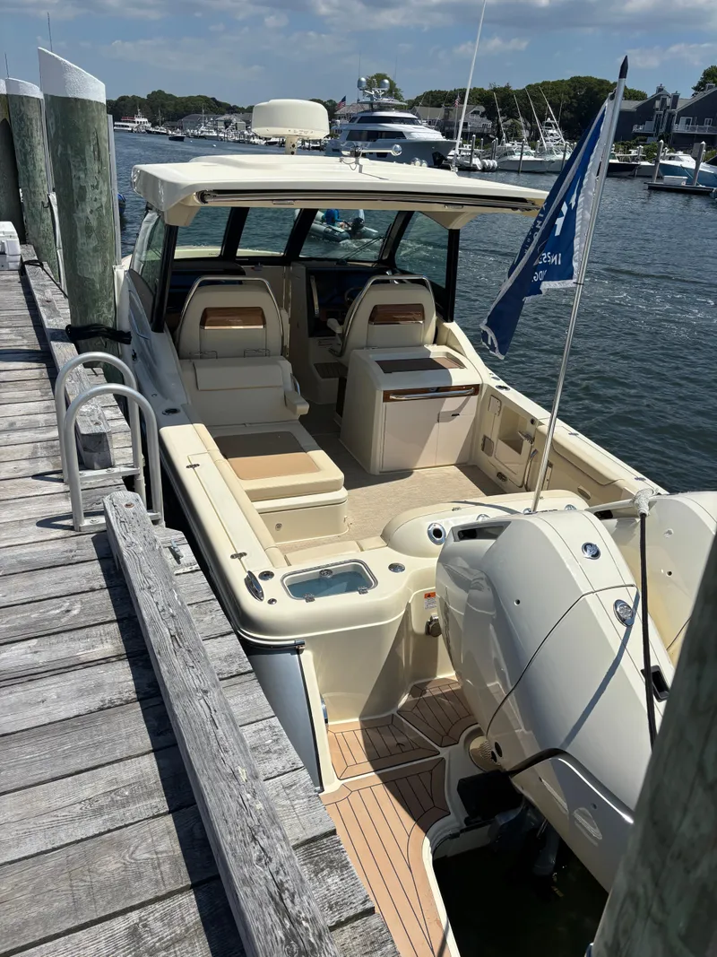 Slide: The Image of 2025 Chris-Craft Calypso 32 docked, showcasing spacious seating and modern design. - 15