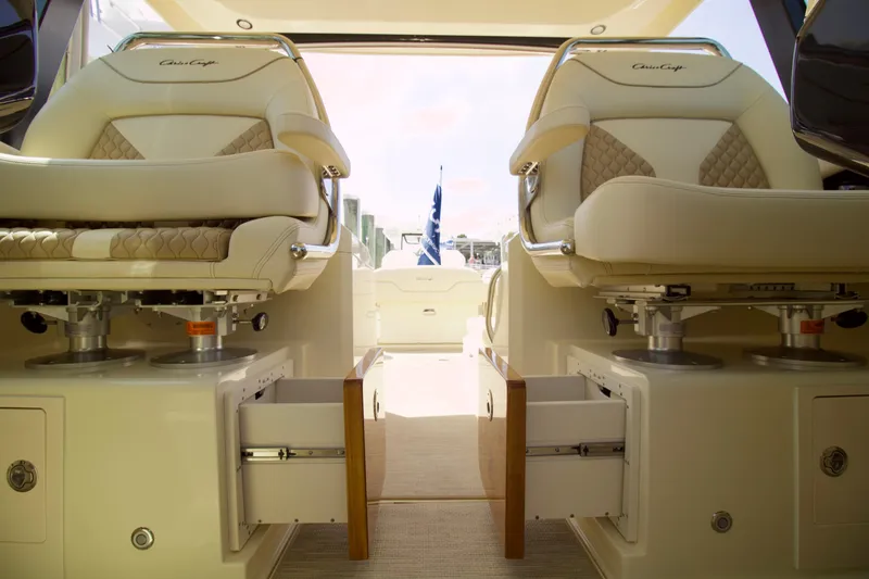 Slide: The Image of 2025 Chris-Craft Calypso 32 interior with luxurious seating and storage drawers. - 17