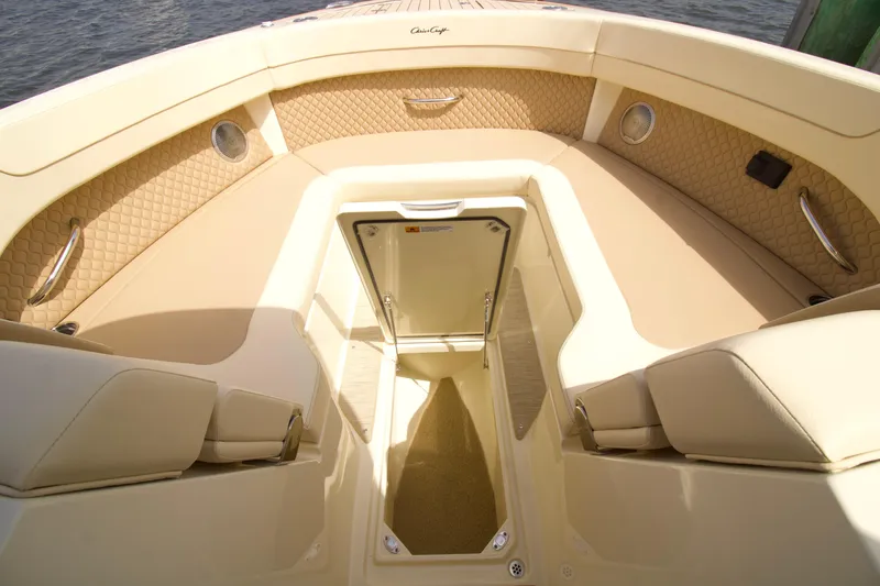 Slide: The Image of 2025 Chris-Craft Calypso 32 boat interior with beige seating and storage compartment. - 21