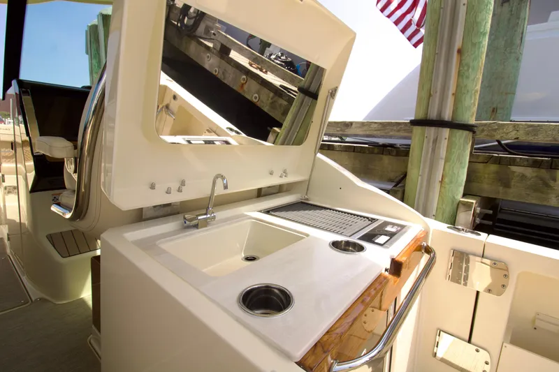 Slide: The Image of 2025 Chris-Craft Calypso 32 boat with outdoor sink and grill station. - 24