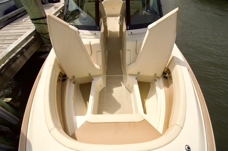 Slide: The Image of 2025 Chris-Craft Calypso 32 boat interior with open storage compartments at dock. - 27