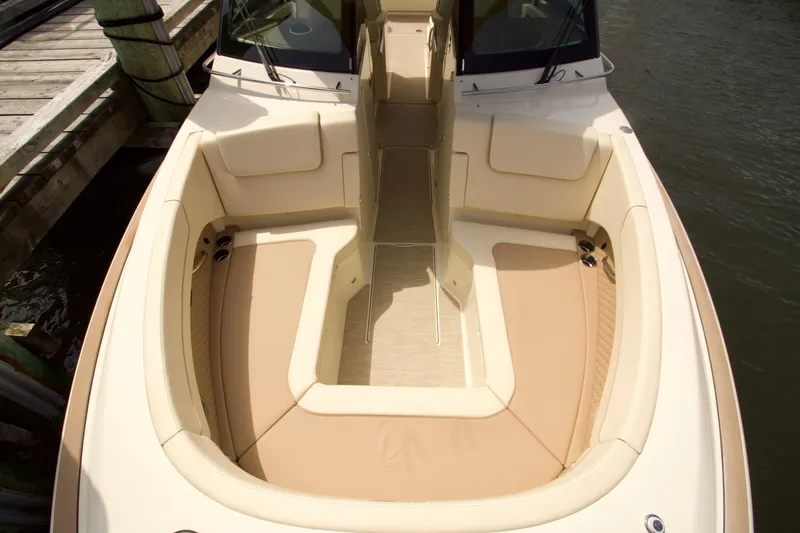 Slide: The Image of 2025 Chris-Craft Calypso 32 boat interior with beige seating and wooden deck. - 28