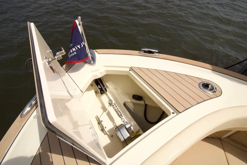 Slide: The Image of 2025 Chris-Craft Calypso 32 boat anchor compartment with open hatch and flag. - 29