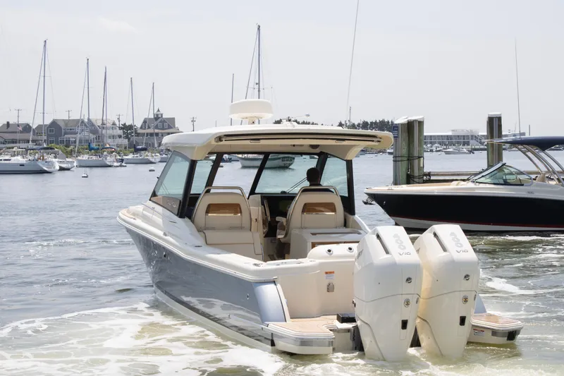 Slide: The Image of 2025 Chris-Craft Calypso 32 boat docked in a marina with twin engines. - 3