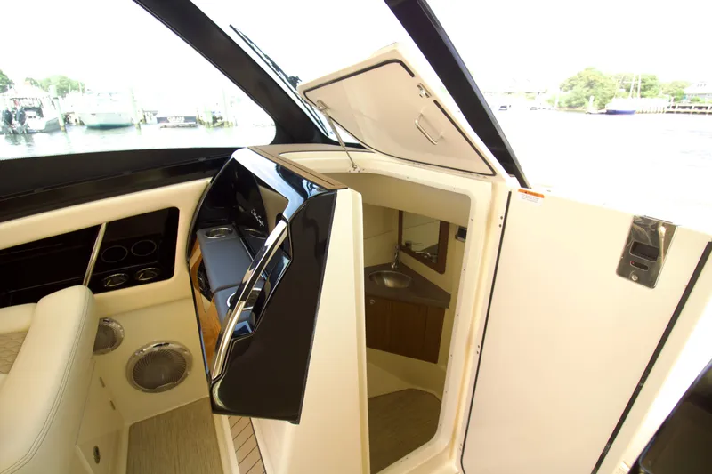 Slide: The Image of 2025 Chris-Craft Calypso 32 interior with helm and cabin entrance. - 35