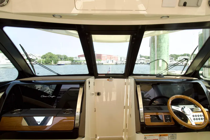 Slide: The Image of Interior view of 2025 Chris-Craft Calypso 32 boat cockpit with steering wheel. - 36