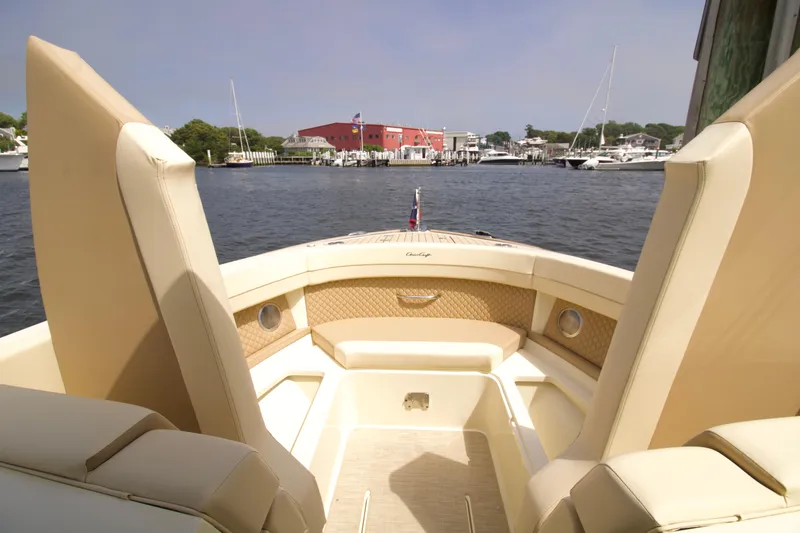 Slide: The Image of 2025 Chris-Craft Calypso 32 boat interior with beige seating, docked in a marina. - 37