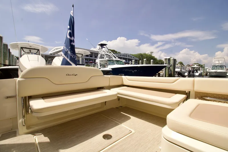 Slide: The Image of 2025 Chris-Craft Calypso 32 boat interior with beige seating at a marina. - 38
