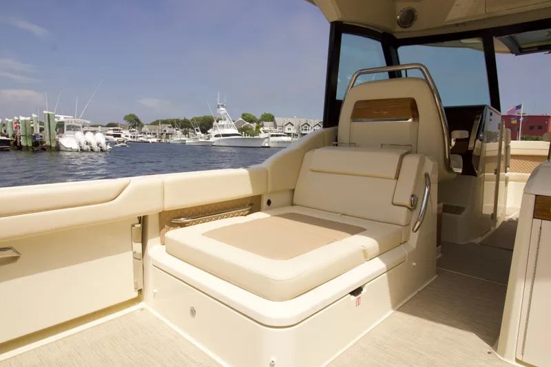 Slide: The Image of 2025 Chris-Craft Calypso 32 boat interior with luxurious seating, docked at a marina. - 39