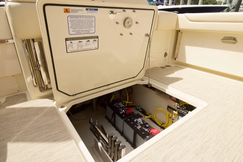 Slide: The Image of Open hatch of 2025 Chris-Craft Calypso 32 showing battery compartment and wiring. - 40